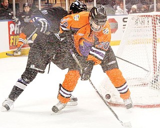 ON THE BRIGHT SIDE: Youngstown Phantoms’ Andrew Lamont (20) and Alex Lippincott (11) of the Fargo Force fight for the puck when the teams met Friday in the first of two games over the weekend at the Covelli Centre. The Phantoms lost both matches, but Lamont was a bright spot in Saturday’s contest, scoring both goals of the night to give him eight for the year.