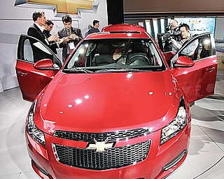 The press gets a close look at the 2011 Chevrolet Cruze after its unveiling at the Los Angeles International Auto Show in Los Angeles. It debuted there last month. This week, the Lordstown-built car is featured at the North American International Auto Show in Detroit.