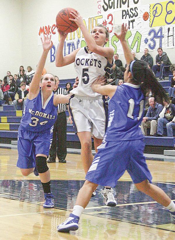 Ashley Moore (5) goes to the hoop as (34) Alexis Pizzulo and (11) Sofia Accordino play defense during their game Monday night.