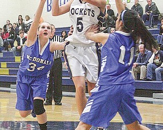 Ashley Moore (5) goes to the hoop as (34) Alexis Pizzulo and (11) Sofia Accordino play defense during their game Monday night.