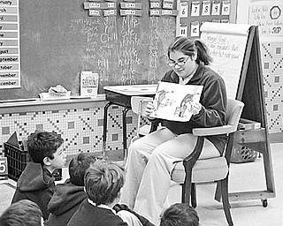 Special to The Vindicator
A LOT TO LEARN: As part of a community service project, Sarah Bivano, a student at Ursuline High School, recently spent some time with pupils in Mrs. Mellony Leonard’s second-grade class at St. Patrick School In Hubbard. She reads the book “If You Give a Moose A Muffin” to the youngsters. They listened attentively and learned about Alaska and Canada, where moose can be found. As a special treat, she gave each student a muffin and learned that if you give second-graders a muffin, it will make them happy.

