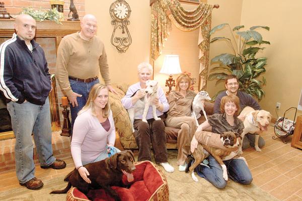COMMON CAUSE: Some residents are trying to gather funds to build a dog park in Boardman Township Park. Standing are Jason Fellows and Richard Fabian. Sitting and kneeling, from left, are Jennifer Fellows with her chocolate Labrador Roscoe, Linda Fabian with her wirehaired terrier Abbey, Vicky Loree with her Italian greyhound Luigi, Abbey Loree with her boxer Izzy and Jason Loree with his Labrador Bowie.