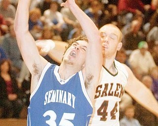 Poland's Luke Wollet manages to score two points despite the defensive attempts of Salem's Mike King (44) and Ryan Wolfgang (22) during the third quarter of a game at Salem High School on Tuesday evening.