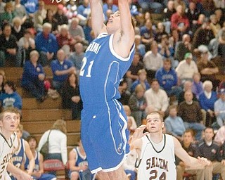 MONSTER GAME: Poland’s David Baker scores two of his 22 points in front of Salem’s Sam Schuster during the third quarter of Tuesday’s game at Salem High School.

