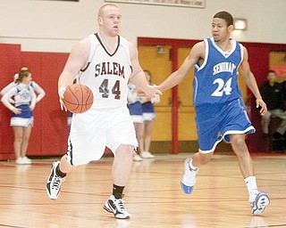 MOVING UP THE FLOOR: Salem’s Mike King dribbles upcourt past Poland’s Ben Donlow during the third quarter of Tuesday’s game at Salem High School.