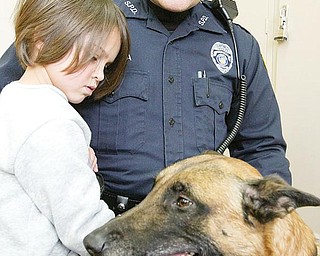 PROTECTOR AND FRIEND: The Campbell Police Department is trying to raise money to buy and train a police dog. Struthers Police Officer Jason Murdza is shown with his police dog, Rebel, and his 4-year-old daughter, Tori. Campbell police have used Rebel to help solve crimes in the city.
