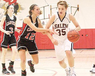 1,000 POINT MILESTONE: Salem’s Amy Scullion (35) drives to the hoop as Canfield’s Kendal Malsch (12) defends during Wednesday’s game at Salem High School. The Cardinals’ 58-48 victory spoiled an historic night for Scullion, an Ohio State recruit, who passed 1,000 career points.
