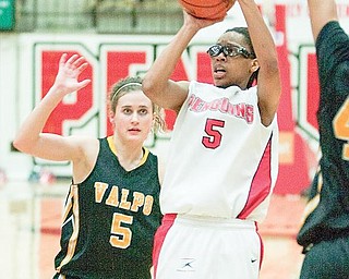 YSU's Kenya Middlebrooks (5) takes a shot in front of Valparaiso's Betsy Adams (5) during the second half of a game at YSU's Beeghley Center on Thursday evening.