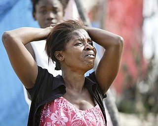 A woman cries after finding the body of a loved one after the earthquake in Port-au-Prince, Wednesday, Jan. 13, 2010. A 7.0-magnitude earthquake hit Haiti on Tuesday.