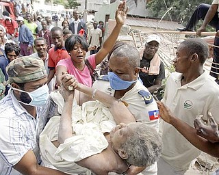 Gladys Loiuis Jeune is pulled alive from the rubble of her home in Port-au-Prince nearly 43 hours after Tuesday's earthquake, where she was greeted by her a cheering crowd Thursday, Jan. 14, 2010.