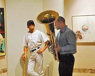 The Vindicator/Robert K. Yosay -----
The College of Fine and Performing Arts - Dana Concert Series presents Music at Noon Concert Series kicked off at the Butler Institute of American Art as part of the Brown Bag Concert series , Every Wednesday at Noon at the Butler . Today was Chamber Music for Brass Quintets.- Eric jernigan warms up on his Tuba under the watchful eye of "the baseball player by 'Marc Sijan-1999' at the Butler.