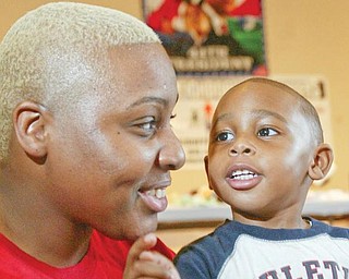Tennequa Mayo of Youngstown, left, and her son Justin, 2, share a moment at the citywide baby shower Monday at the McGuffey Centre in Youngstown.