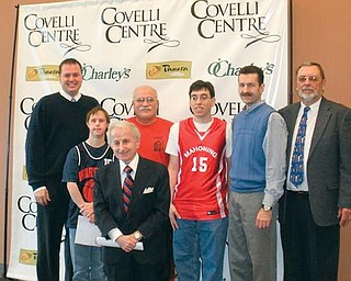 BASKETBALL SERIES: Tony Lariccia (first row), main sponsor for the Lariccia Family High School Basketball Series that begins Tuesday at the Covelli Centre, said that the annual event is to help young people at Monday’s press conference in the Community Room of the Covelli Centre. Back row. Eric Ryan, Centre executive director; Eric Trebus, Mahoning County Public Warriors’ player; Terry Bacha Sr., Mahoning County Indians’ coach; Matt Jurczyk, an Indians’ player; Michael Koken, St. Christine’s School athletic director; Paul Andraso, administrator-treasurer of the Series.