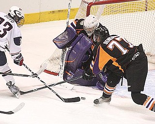 NET PLAY: Youngstown Phantoms goalie Mike Mahalak and defenseman Dan Senkbeil try to keep Team USA’s Travis Boyd (93) from scoring during Monday’s game at the Covelli Centre.