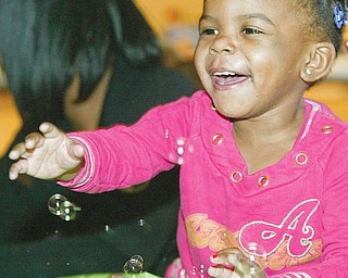 GAME TIME: Lyric Saulsberry, 2, plays a game at the citywide baby shower at the McGuffey Centre in Youngstown. She attended the event Monday with her mother, Latasha Saulsberry of Youngstown. It was the 4th annual citywide baby shower sponsored by the Associated Neighborhood Centers’ McGuffey Centre.