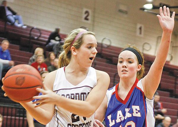 GAME ACTION: Boardman’s Brooke Meenachan (21) looks to pass while Lake’s Jordan Jackson defends. The Spartans defeated Federal League rival Uniontown Lake 65-37.
