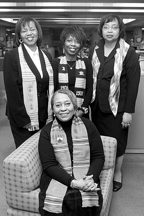 LADIES IN WAITING: Satisfied that arrangements have been completed for the Black and White Snowflake Ball, to be sponsored by the Epsilon Mu Omega Chapter of Alpha Kappa Alpha Sorority, are, seated, Sarah Brown-Clark, member of the program committee; and standing from left, Beverly Fortune, chair of the event; Robin Bradley, ticket chair; and Carole Staten, technology chair. 