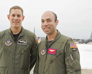 First Lieutenant and Co-Pilot Steve Stroney of Liberty with Pilot and Major Joe George of Pittsburgh with the C130 - H2 Aircraft behind them.