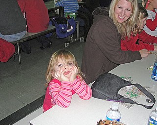 Delaney Gallagher, 2, waits patiently for mom Richelle and sister Mikayla, 8, to fill out their bingo cards. 