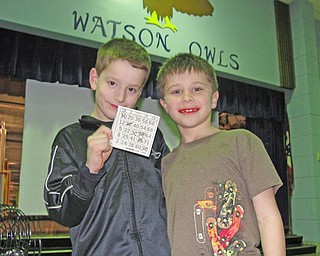 Alex Miller, 8, celebrates his bingo victory with classmate Lorenzo Russo, 8.
