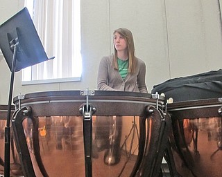 Senior Lauren DiCola focuses on her sheet music as she pounds away on the timpani drums.