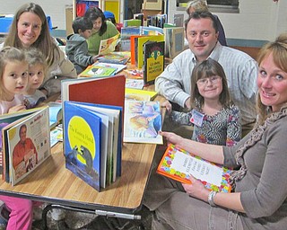 Dobbin's Literacy Night is not just for kids, it's a family affair. Parents are reminded of how fun animated stories can be. Sudha Rabindra (left) and mother Ashlin Rabindra are in the background reading.
From front left: Kim Simon, Laurel Simon, Stacie Zarbaugh, Jeff Simon, Zoe Simon and Kim  Simon.