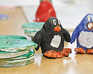 The Vindicator/Lisa-Ann Ishihara ---Boardman Glenwood Middle School students created board games in their art class and got the opportunity to play them afterschool with classmates in the cafeteria. Pictured here  are game pieces from "Penguinopoly"