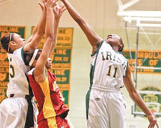 The Vindicator/Lisa-Ann Ishihara--- Ursuline Aurielle Irizarry (5) and Kaneesha Tensley (11) and Mooney Chyna Davis (3) go after the rebound during the second period Thursday night.