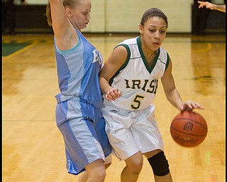 The Vindicator/Geoffrey Hauschild.Ursuline's Aurielle Irizzary (5) makes her way down court while defended by East's Alex Hines (5) during the second quarter of a game at Ursuline High School on Thursday evening.