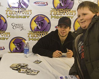 Robert Nottingham (9) of Struthers poses with Pittsburgh Penguins Center Tyler Kennedy (48) at his meet and greet with fans at Covelli Centre Friday evening before the Phantoms game against the Sioux Falls Stampede.