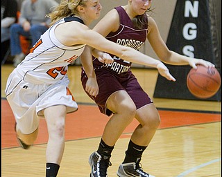 The Vindicator/Geoffrey Hauschild.Boardman's Monica Touvelle (32) shields the ball from Hoover's Lindsey Fiala (24) during the third quarter of a game at Hoover High School on Saturday afternoon.