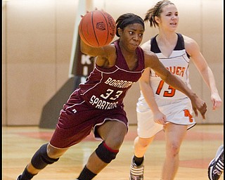 The Vindicator/Geoffrey Hauschild.Boardman's Doriyon Glass (33) drives down court past Hoover's Hannah Romano (13) during the fourth quarter of a game at Hoover High School on Saturday afternoon.