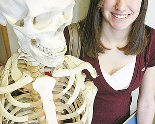 William D. Lewis/The Vindicator Girard HS 10 th grader Bryanna Jay poses for a portriat near a skeleton in hte school's biology room.