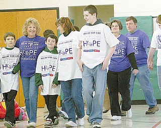 SURVIVOR WALK: Members of the Fisher family joined their adopted grandma, Patty Boyle, for her survivor walk at the Relay for Life at St. Patrick School in Hubbard. From left, John, 12; Patty Boyle; Joe, 10; Michelle; and Billy, 13, walk in the gymnasium at St. Patrick School.