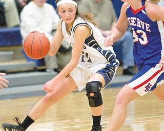 Lowellville's Taylor Hvisdak (12) changes direction to avoid Western Reserve's Tori Korda (33) during the fourth quarter of a game at Lowellville High School on Monday evening.