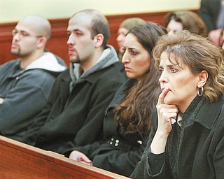 VICTIM’S SISTER: Terri Rasul, right, of Youngstown, a sister of slain shopkeeper Isam Salman, listens to legal arguments during a 7th District Court of Appeals hearing Tuesday on whether Mark Aaron Brown should get a new trial for the 1994 murder of her brother and Hayder Al-Turk, a clerk at the Midway Market on Elm Street. Other members of the victims’ families are at left. Brown’s execution is set for Thursday.