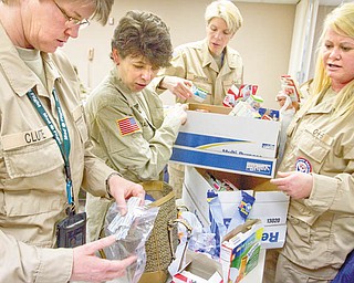 (Left-Right) Nurses (RNs) Lynne Clute and Perse Diakakis and Social Workers Diane Sharneck and Carrie Galbreath distribute food, medical supplies, and hygiene products, donated by Diane Reese of Briar Field Manor, to members of a St. Elizabeth sponsored emergency team at St. Elizabeths on Tuesday evening.