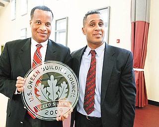 GREEN AWARD: Youngstown Mayor Jay Williams, left, accepts the U.S. Green Building Council’s Leadership in Energy and Environmental Design Silver Award from Clifford Scott, director of the Youngstown Metropolitan Housing Authority. The presentation was Tuesday at the Arlington Heights Recreation Center, the building that won the award. The city owns and operates the recreation center.