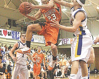 Michael Johnson (23) gets fouled on the way to the hoop by (24) Matthias Tayala during their game Tuesday night in McDonald.