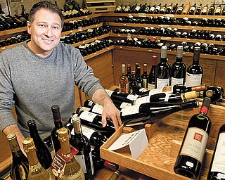 BEER RETAILER: Phill Reda, owner of Vintage Estate, poses with some of the more than 1,000 labels of wine in his beer and wine retailer operation. The company was named best beer retailer in the world by www.ratebeer.com.