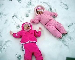 Kalynn Robenolt of Austintown, daughter of Amanda Robenolt, and Ryleigh DeLisio of Boardman, daughter of Abbi DeLisio, enjoy playing in the snow.