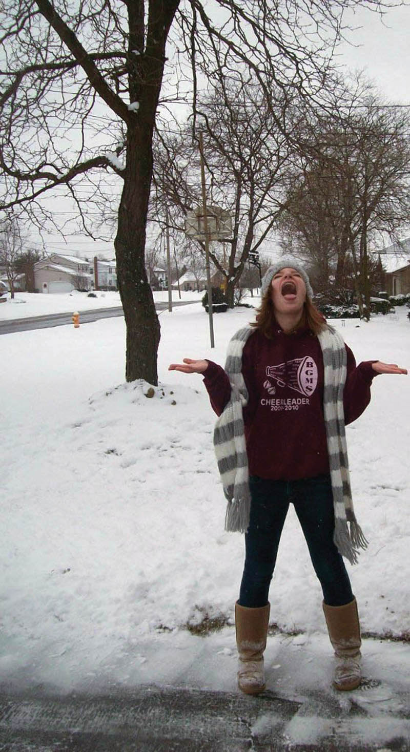 Samantha Janis, 13, of Youngstown, tries to catch snowflakes.