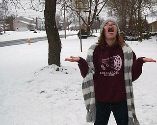 Samantha Janis, 13, of Youngstown, tries to catch snowflakes.
