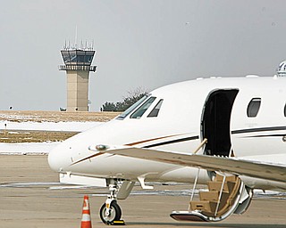 CHANGE ON HORIZON? A private jet sits at Winner Aviation at Youngstown-Warren Regional Airport with the FAA control tower in the background. The Federal Aviation Administration is proposing to move some air traffic controllers at the regional airport in Vienna to Cleveland Hopkins Airport. 