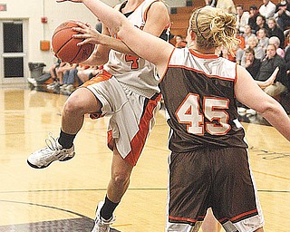 TIGERS ROAR TO THE WIN:East Palestine’s Chelsea Stewart (45) tries to stop Springfield’s Andria Lyons (4) as Lyons drives to the hoop during Thursday’s game at the Tigers’ gymnasium in New Middletown. Lyons posted 13 points for the Tigers, who avenged their only Inter Tri-County League loss this season by defeating their Tier One rivals, 52-37.