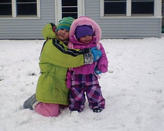 Gina Milone, 6, and Lorelai Nemes, 17 months, both of Struthers. This was LorelaiÕs first time in the snow, and Gina is her best friend and neighbor..