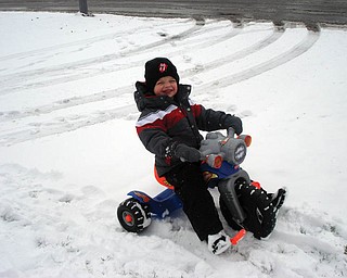 John Darnley, 3, of Mineral Ridge, is playing in the snow on his motorcycle..