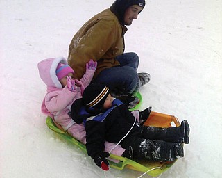 Dad,Buddy, with daughter Kayla from New Middletown and friend Nathan from Mineral Ridge sledding at Mill Creek Park.