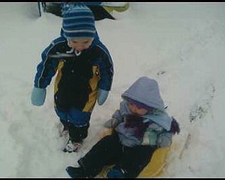 Henry and Sophia Detwiler, of Greensburg, Pa., go sledding. Their grandmother Donna Detwiler of North Lima.