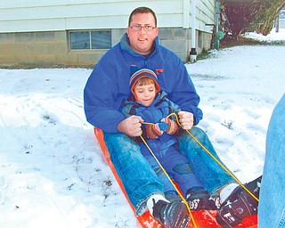 Oscar Wolf Calipari of Buffalo, N.Y., pictured with his uncle, Brian Wolf of Florida, was visiting his grandparents, Brian and Kathy Wolf of Liberty, over the Christmas holiday. The two guys had been tobogganing..